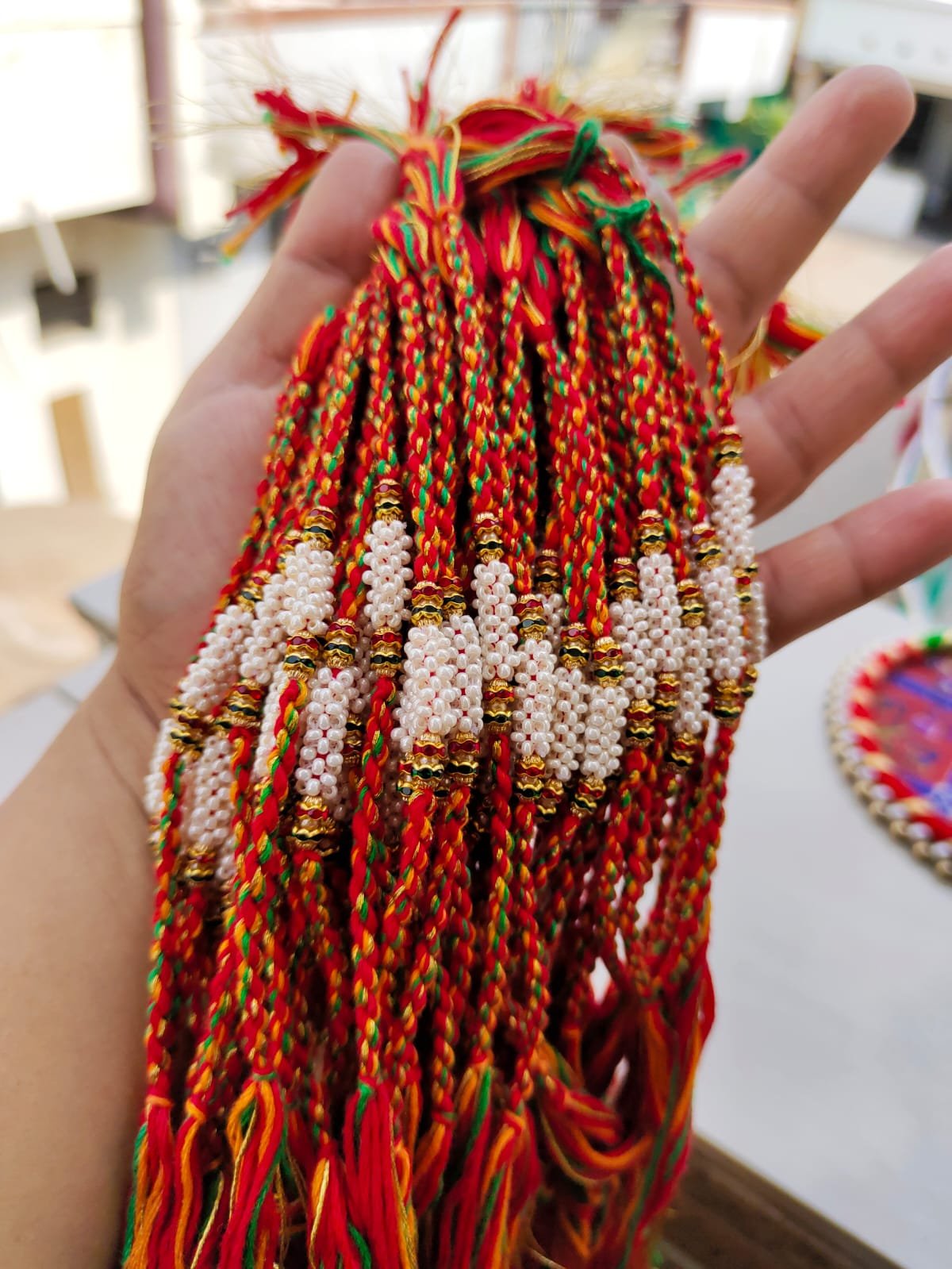 Handcrafted Cylindrical Pearl Cluster Designer Rakhi Collection - Image 3