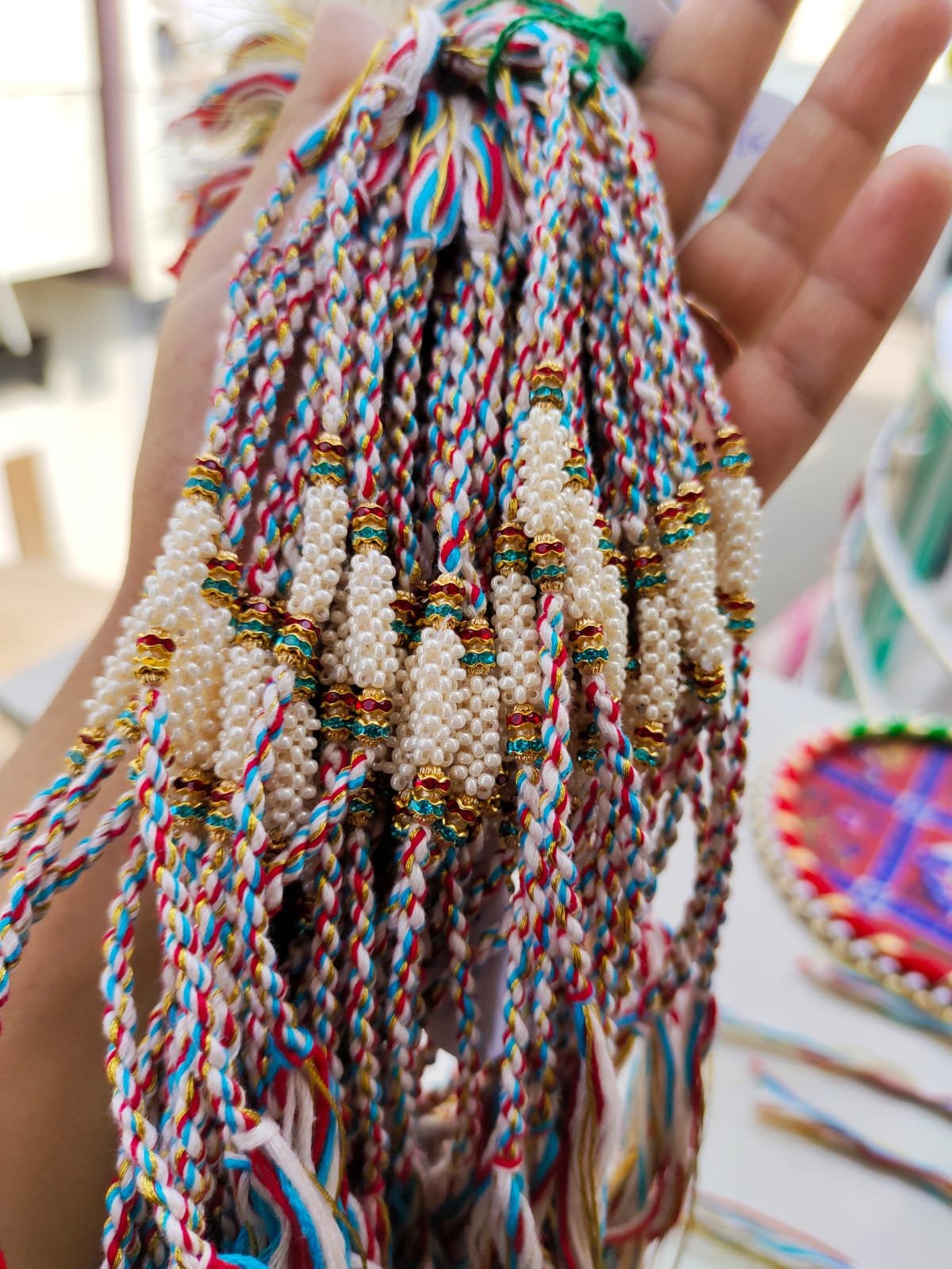 Handcrafted Cylindrical Pearl Cluster Designer Rakhi Collection