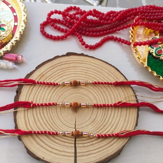 Minimalist Sacred Rudraksha Golden-Zari Red Thread Designer Rakhi (Single Piece)